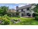 Backyard features a serene pond, lush landscaping, a deck, and ample space for entertaining at 14814 Beacon Blvd, Carmel, IN 46032
