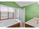 Bright bathroom with a jetted tub, tiled shower, and a window for natural light at 14814 Beacon Blvd, Carmel, IN 46032