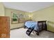 Cozy bedroom with a wooden framed bed and a large window overlooking the backyard at 14814 Beacon Blvd, Carmel, IN 46032