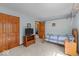 Bright bedroom featuring wood floors, a closet, and a large window for natural light at 14814 Beacon Blvd, Carmel, IN 46032