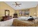 Comfortable bedroom featuring a ceiling fan, large window, and classic furniture at 14814 Beacon Blvd, Carmel, IN 46032