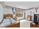 Spacious bedroom with natural light, decorated with sports memorabilia and wood furnishings at 14814 Beacon Blvd, Carmel, IN 46032