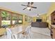 Light-filled dining area with large windows, ceiling fan, and views of the backyard at 14814 Beacon Blvd, Carmel, IN 46032