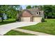 View of the property featuring a two-car garage and a spacious well manicured yard at 14814 Beacon Blvd, Carmel, IN 46032