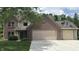 Charming two-story brick home featuring an attached two-car garage and a neatly manicured lawn at 14814 Beacon Blvd, Carmel, IN 46032