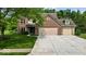 Charming two-story brick home with a spacious driveway and well-maintained lawn at 14814 Beacon Blvd, Carmel, IN 46032