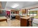 Cozy kitchen with warm wood cabinets, stainless steel appliances, a breakfast bar, and tiled floors at 14814 Beacon Blvd, Carmel, IN 46032