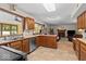 Traditional kitchen with wood cabinets, stainless steel appliances, and tile flooring with views to living area at 14814 Beacon Blvd, Carmel, IN 46032
