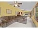 Spacious living area boasting a large sectional couch, hardwood trim, and access to the backyard at 14814 Beacon Blvd, Carmel, IN 46032