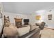 Cozy living room featuring a brick fireplace, comfortable seating, and a television entertainment center at 14814 Beacon Blvd, Carmel, IN 46032