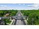 Street view featuring a pedestrian bridge and lush landscaping for a serene community experience at 14814 Beacon Blvd, Carmel, IN 46032