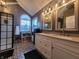 Modern bathroom boasts double sinks, patterned tile flooring, and a stylish shower at 1714 Michelle Mnr, Danville, IN 46122