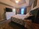Bright main bedroom featuring a large bed, dresser, and a view of the outdoors at 1714 Michelle Mnr, Danville, IN 46122