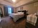 Spacious primary bedroom with a tray ceiling, carpet flooring, and natural light at 1714 Michelle Mnr, Danville, IN 46122