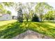 Expansive backyard with mature trees, lush green grass, storage shed, and outdoor entertaining area at 18021 Sanibel Cir, Noblesville, IN 46062