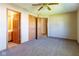 Spacious bedroom with neutral carpeting, ceiling fan, and multiple closets for ample storage at 18021 Sanibel Cir, Noblesville, IN 46062