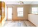 Bright kitchen dining area with light wood flooring, windows, and white trim at 18021 Sanibel Cir, Noblesville, IN 46062