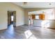 Open-concept living room featuring stylish gray wood flooring and access to the kitchen at 18021 Sanibel Cir, Noblesville, IN 46062