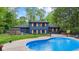 Captivating backyard featuring a beautiful pool, green grass, and the home's rear exterior at 1829 Kessler Blvd W Dr, Indianapolis, IN 46228