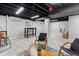 Finished basement features an exposed ceiling, light gray walls, and vinyl plank flooring at 1829 Kessler Blvd W Dr, Indianapolis, IN 46228