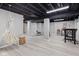Spacious finished basement with a decorative hammock chair and bar seating area at 1829 Kessler Blvd W Dr, Indianapolis, IN 46228