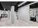 Finished basement with neutral walls and black ceilings, creating a modern space at 1829 Kessler Blvd W Dr, Indianapolis, IN 46228