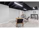 Finished basement featuring modern flooring and a cozy seating area at 1829 Kessler Blvd W Dr, Indianapolis, IN 46228
