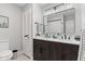 Updated bathroom boasts dual sinks, and dark vanity with a herringbone pattern at 1829 Kessler Blvd W Dr, Indianapolis, IN 46228