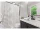 This bathroom has a black faucet, dark cabinets, a white counter, and a shower-tub combo at 1829 Kessler Blvd W Dr, Indianapolis, IN 46228