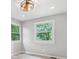 Neutral bedroom showcases corner windows with green views and modern ceiling fan at 1829 Kessler Blvd W Dr, Indianapolis, IN 46228