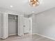 This bedroom has light hard wood floors, light grey walls, and a bi-fold door closet at 1829 Kessler Blvd W Dr, Indianapolis, IN 46228