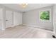 Bright bedroom featuring closet, light colored flooring, and ample natural light from the window at 1829 Kessler Blvd W Dr, Indianapolis, IN 46228