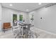 Bright dining area with white trim, French doors to the pool, and light wood flooring at 1829 Kessler Blvd W Dr, Indianapolis, IN 46228
