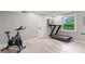 Bright exercise room equipped with modern treadmill and Pooboo exercise bicycle at 1829 Kessler Blvd W Dr, Indianapolis, IN 46228