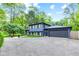 Home exterior featuring a lush green lawn and large tree in front of a well-maintained home at 1829 Kessler Blvd W Dr, Indianapolis, IN 46228