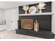 Stylish fireplace featuring a decorative screen, white mantle, and black brick surround at 1829 Kessler Blvd W Dr, Indianapolis, IN 46228