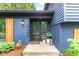 Charming home exterior showcases a blue painted facade with a cozy front entrance and decorative plants at 1829 Kessler Blvd W Dr, Indianapolis, IN 46228