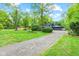 Home featuring a spacious yard, mature trees, and a long driveway leading to the house at 1829 Kessler Blvd W Dr, Indianapolis, IN 46228