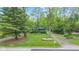 Serene home exterior with a spacious yard and mature trees offering a peaceful and private setting at 1829 Kessler Blvd W Dr, Indianapolis, IN 46228
