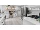 Spacious kitchen with white cabinets, stainless steel appliances, and open shelving at 1829 Kessler Blvd W Dr, Indianapolis, IN 46228