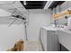 Laundry room featuring modern appliances, ample shelving for storage and light vinyl floors at 1829 Kessler Blvd W Dr, Indianapolis, IN 46228