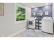 Clean laundry room with side-by-side washer and dryer and a modern, organized look at 1829 Kessler Blvd W Dr, Indianapolis, IN 46228