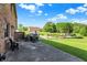 Landscaped backyard with patio, outbuilding, and green lawn at 186 W 600 N, Alexandria, IN 46001
