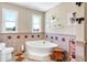This bathroom includes a corner tub and neutral tiling throughout, creating a relaxing space at 186 W 600 N, Alexandria, IN 46001