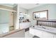 Bright bathroom featuring double sinks, a tiled shower, and a soaking tub by a window at 186 W 600 N, Alexandria, IN 46001