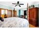 Spacious bedroom with a four poster bed, a ceiling fan, and a large wooden wardrobe at 186 W 600 N, Alexandria, IN 46001