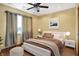 Cozy bedroom with a queen bed, a ceiling fan, and an accent wall with a scenic picture at 186 W 600 N, Alexandria, IN 46001