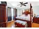 Spacious bedroom with a dark wooden four-poster bed, hardwood floors, and soft blue walls at 186 W 600 N, Alexandria, IN 46001