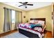 Bright bedroom with a queen bed, hardwood floors, a ceiling fan, and matching curtains at 186 W 600 N, Alexandria, IN 46001