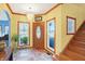 Welcoming foyer with tile floor, chandelier, wood trim and staircase at 186 W 600 N, Alexandria, IN 46001